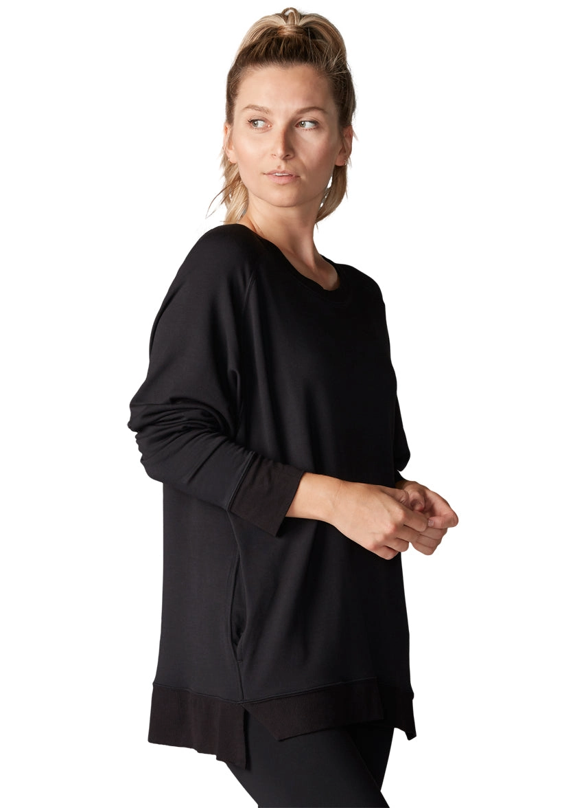 black v neck bodysuit drying flat on a rack